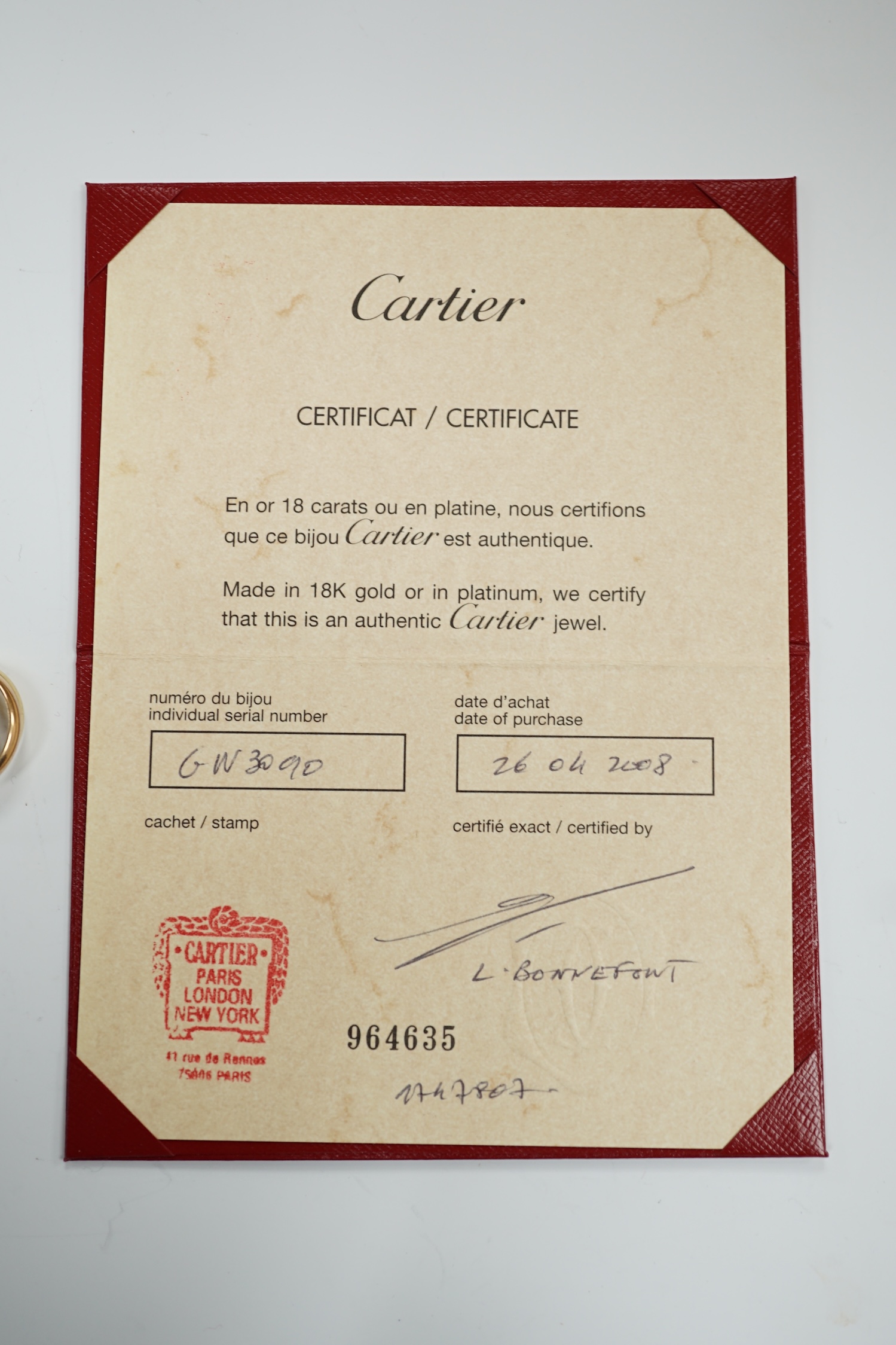 A modern Cartier three colour 750 Russian wedding ring, signed and numbered GW3090, size P, 9.7 grams, with Cartier certificate dated 2008.